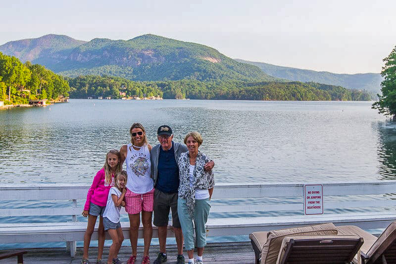 family hugging with views of lake lure and the mountains