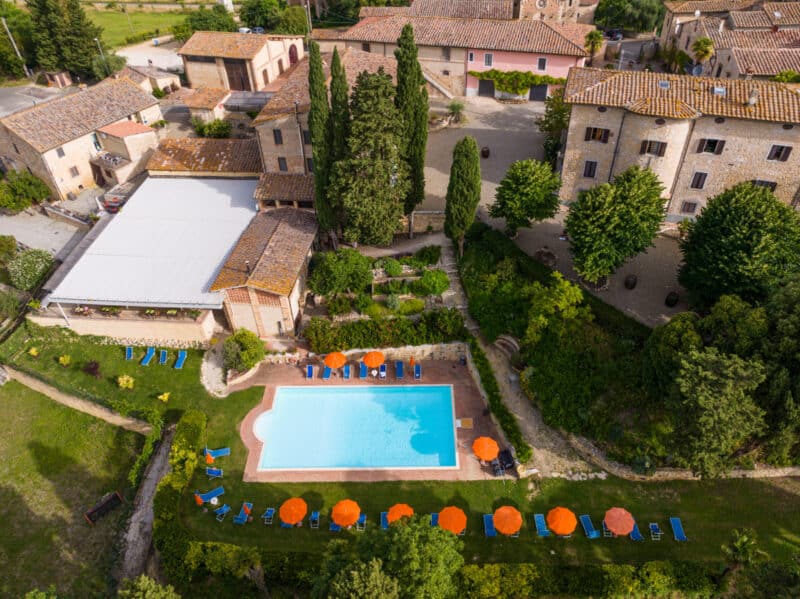 aerial view of tuscan farm and swimming pool